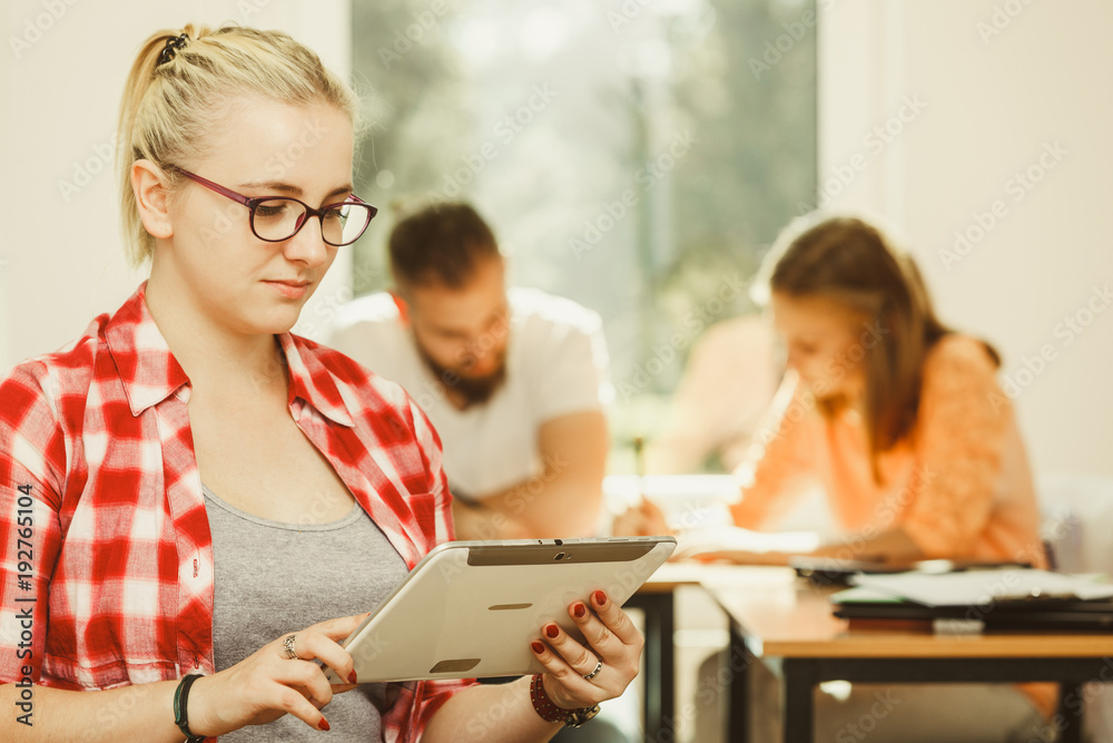 Student girl with tablet in front of her classmates Student girl with tablet in front of her classmates