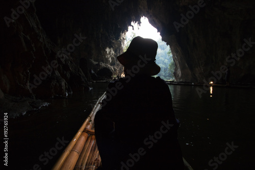 Silhouette Woman on bamboo raft at Tham Lod, a cave system in Mae Hong Son Province, northern Thailand
