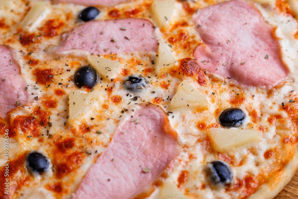 Close up texture of pizza with ham and black olives, macro. Italian food, restaurant menu concept