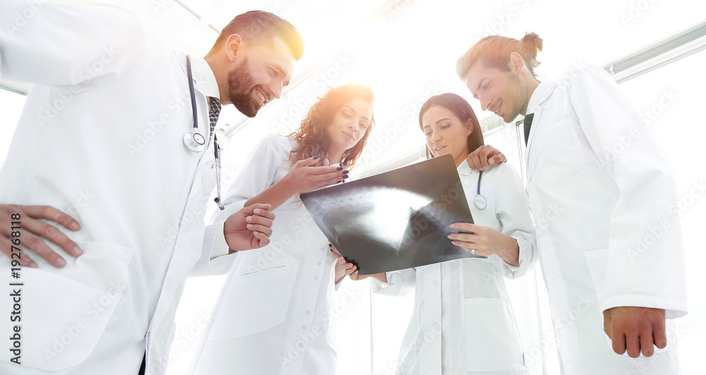 group of doctors discussing an x-ray group of doctors discussing an x-ray