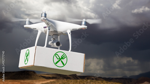Unmanned Aircraft System (UAV) Quadcopter Drone Carrying Package With Food Symbol Label Near Stormy Skies.