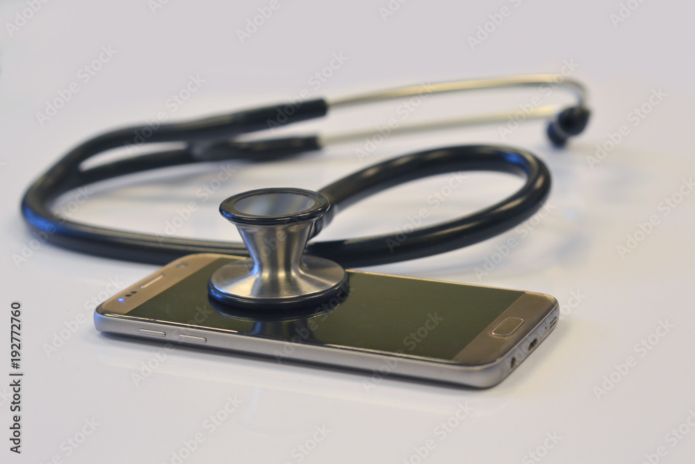 Stehoscope with Cell Phone on White Clinic Table Stehoscope with Cell Phone on White Clinic Table
