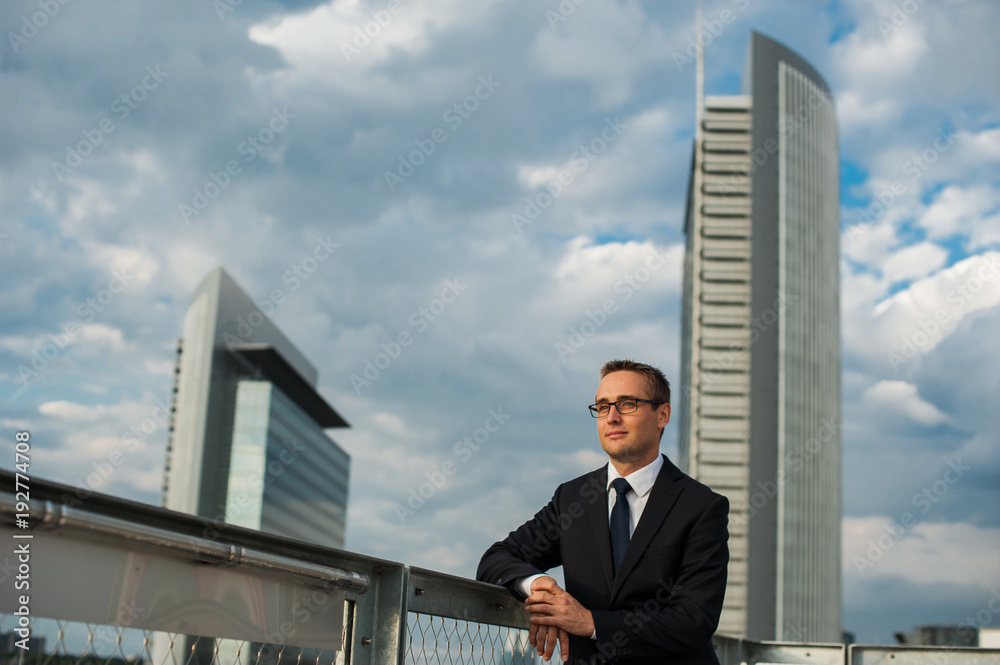 Portrait of businessman standing in front of modern building Portrait of businessman standing in front of modern building