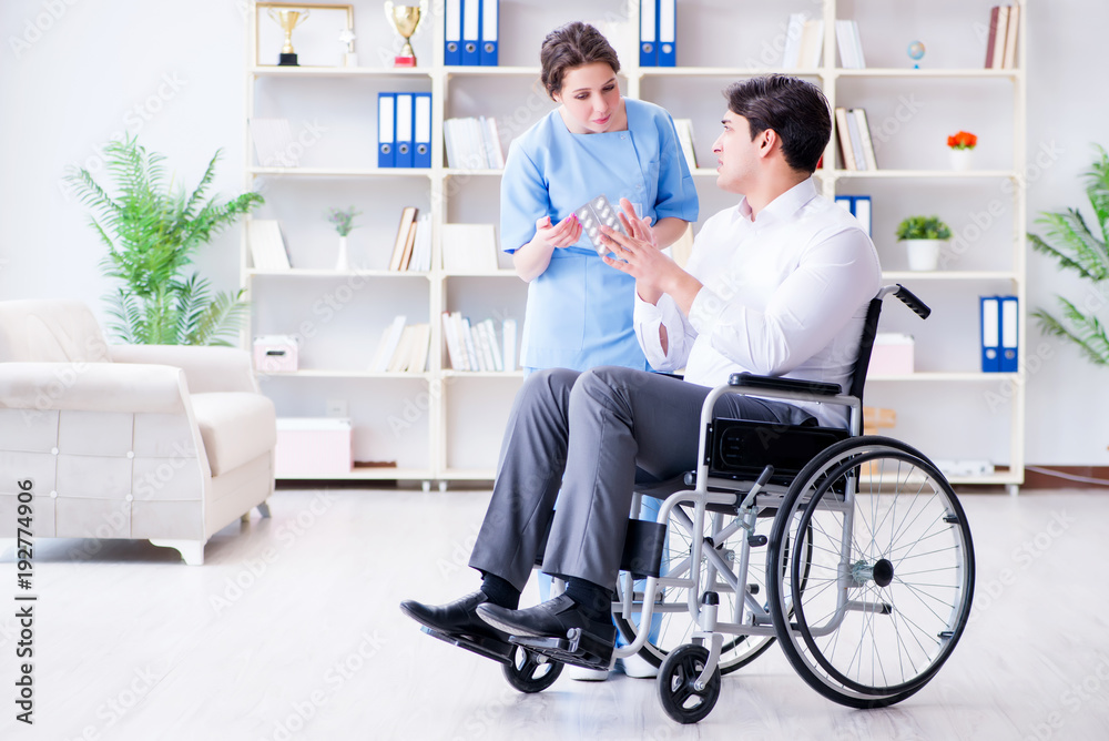 Disabled patient on wheelchair visiting doctor for regular check Disabled patient on wheelchair visiting doctor for regular check