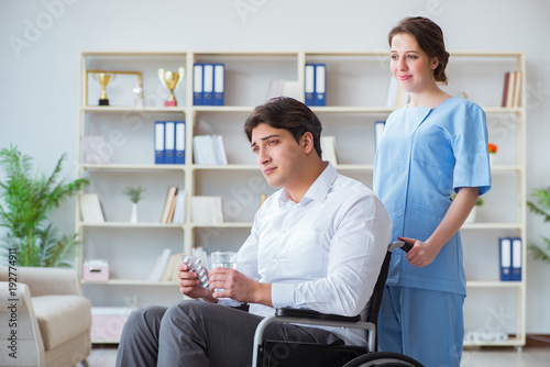 Disabled patient on wheelchair visiting doctor for regular check