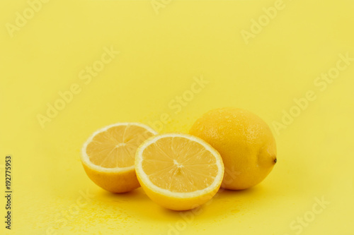 Yellow lemons stock images. Lemons on a yellow background. Juicy pieces of lemons