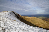 Pen y Fan and Corn Du are the highest mountains in the Brecon Beacons National Park. Panoramic format with winter snow.