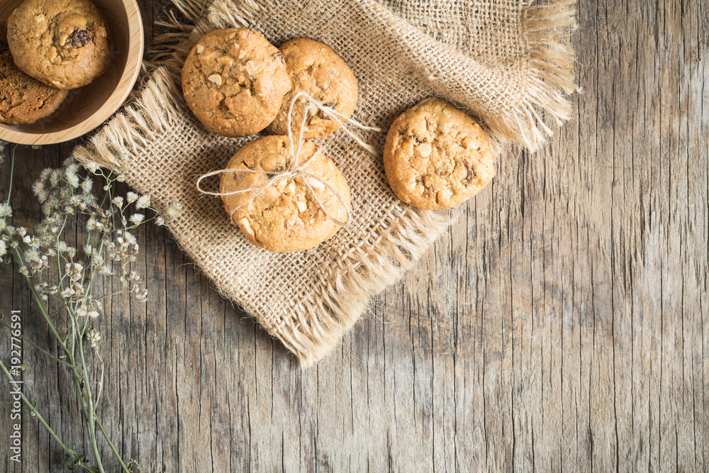 Fototapeta premium Top view and overhead shot of cookies on old wooden background,Homemade cookies on sackcloth
