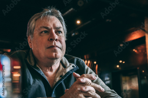 older man sitting at bar or restaurant