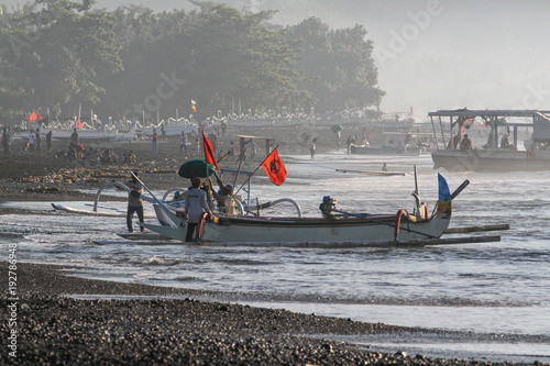 Bringing a fishing boat to shore in Kasumba, a traditional fishing village on Bali's southern coast, Indonesia photo