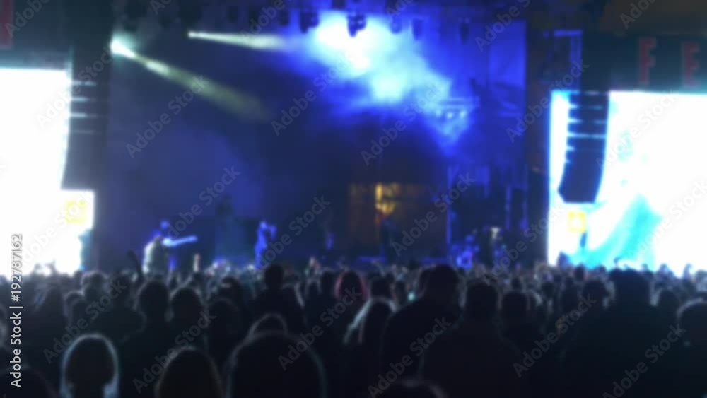 Iconic night rock concert front row crowd cheering slomo 100p.Night rock concert.People cheer move lift and clap their hands in unison against the strobing stage lights. Iconic night rock concert front row crowd cheering slomo 100p.Night rock concert.People cheer move lift and clap their hands in unison against the strobing stage lights.