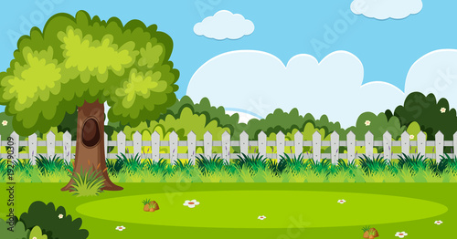 Background scene with tree and white fence in garden