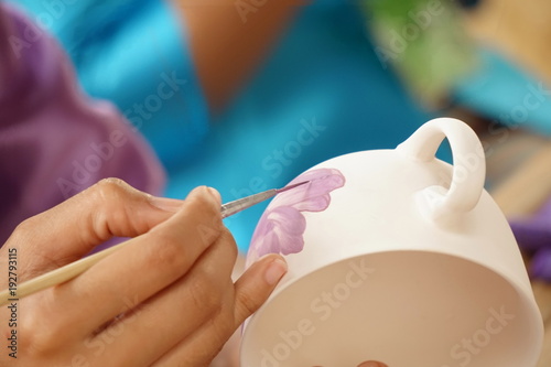 Female hand painted works in the cups a process before sales