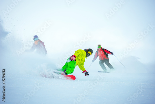 Ski downhill concept with group of snowboarders