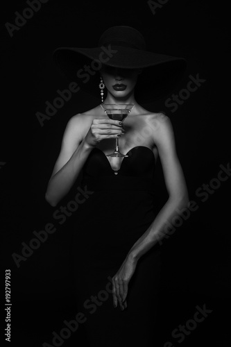 Luxury woman in a black hat with Martini glass in hand.