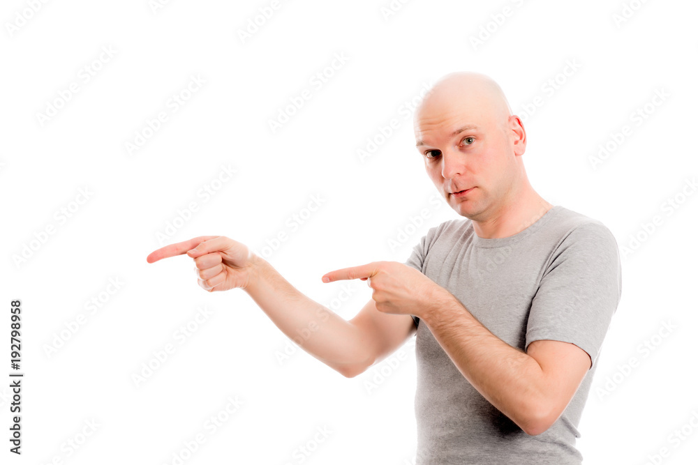 man with bald head in gray shirt is pointing to the side