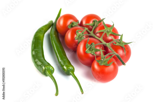 tomatoes and green peppers on a white background
