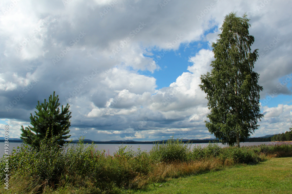 Beach by Orsa lake in Dalarna, Sweden, in August. Beach by Orsa lake in Dalarna, Sweden, in August.