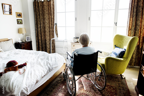 Senior woman sitting on the wheelchair alone