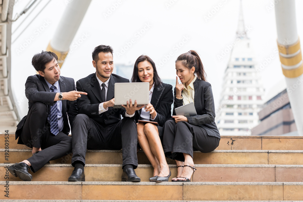 Portrait image of Two Asia businessmen and two businesswomen meeting discussing ideas for project and working in the city. Architecture concept Young business people Portrait image of Two Asia businessmen and two businesswomen meeting discussing ideas for project and working in the city. Architecture concept Young business people