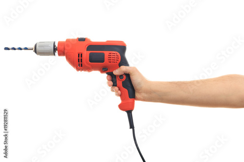 Hand holding an electric drill on white background