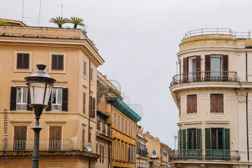 Fototapeta premium European windows with wooden shutters. Old house exterior.
