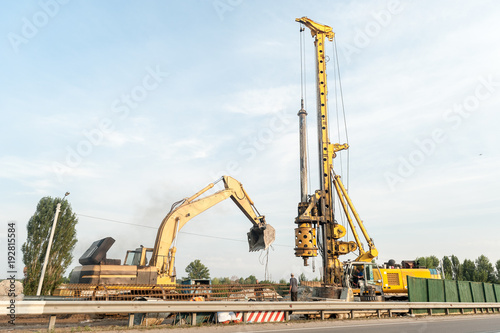 The machine for drilling wells and installing piles and excavator