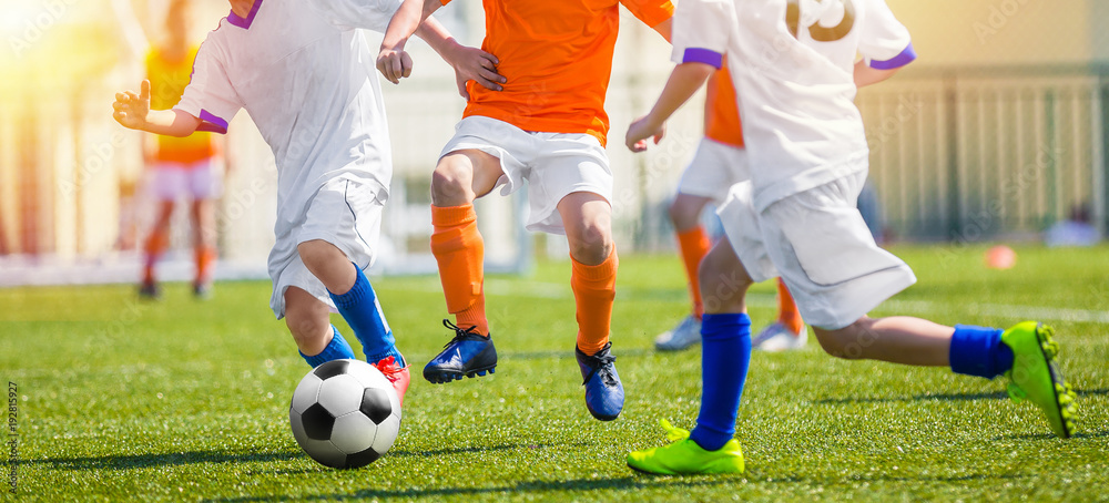Child Having Fun Playing Soccer Game. Youth Soccer Match for Kids. Outdoor Football Tournament on School Pitch. Young Footballlers Running the Ball Child Having Fun Playing Soccer Game. Youth Soccer Match for Kids. Outdoor Football Tournament on School Pitch. Young Footballlers Running the Ball