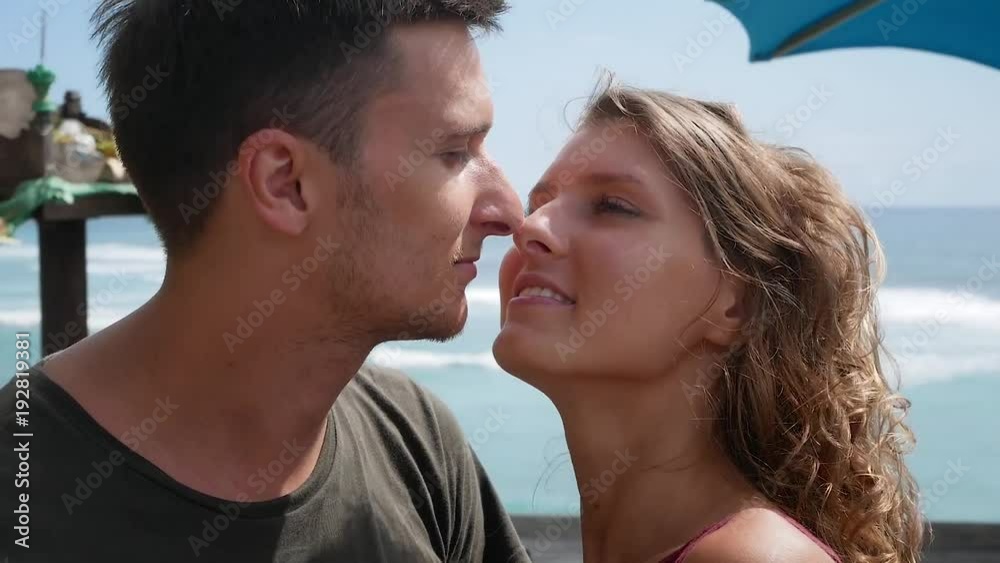 Romantic young couple kissing on shore cliff, Bali Romantic young couple kissing on shore cliff, Bali