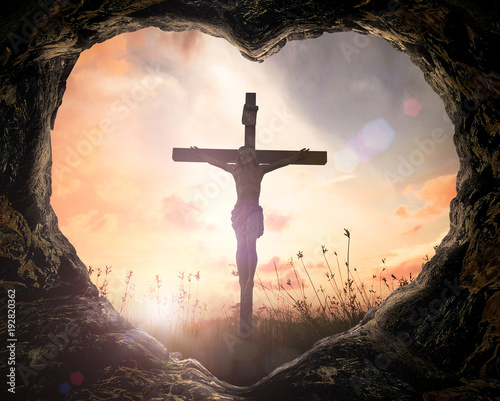 Good Friday concept: Heart shape of cave with Jesus Christ on cross over meadow sunset background.