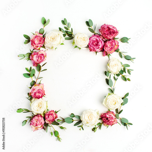Floral frame wreath made of red and white rose flowers and eucalyptus branches. Flat lay, top view mockup with copy space.