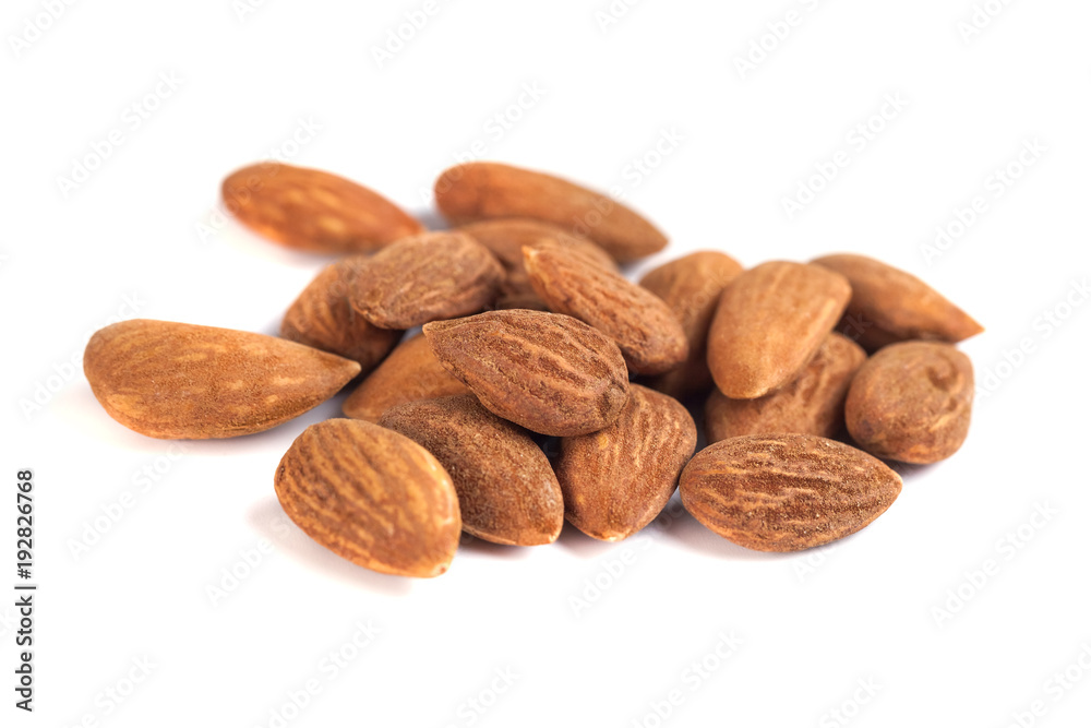 heap of brown roast almonds on white background heap of brown roast almonds on white background
