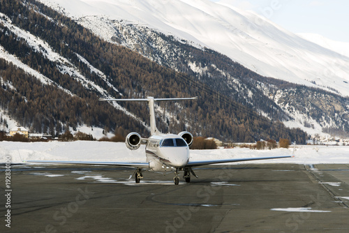 A private jet is ready to take off in the airport of St Moritz Switzerland in winter