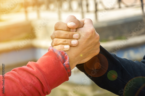 holding hand, friendship concept, bond of friendship, fellowship with lens flare © Rikesh