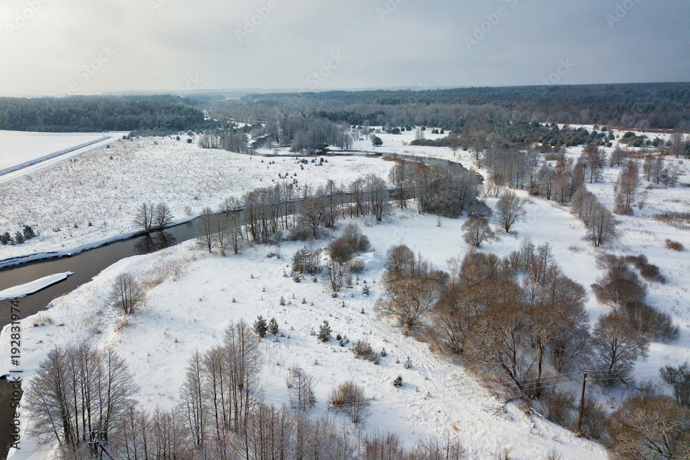 Aerial view of forest river in winter day