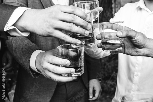 Guests congratulate the newlyweds with a glass of champagne in their hands.