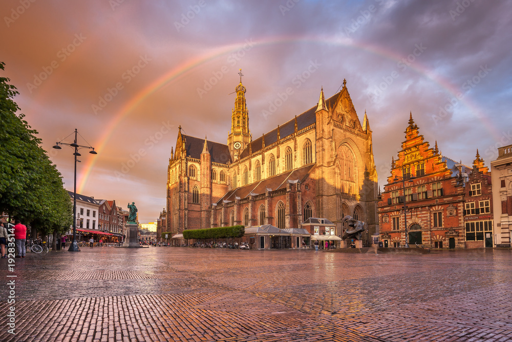 Breathtaking  sunset with rainbow over Grote Kerk in Haarlem city
