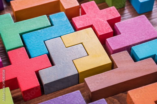The concept of logical thinking. Geometric shapes on a wooden background.