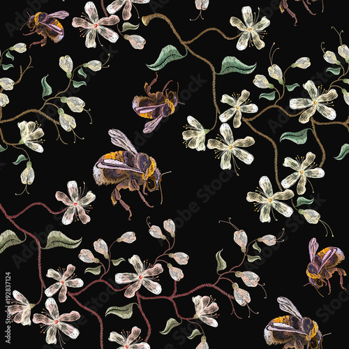 Sakura bloom and bumblebee embroidery seamless pattern. Beautiful flowers. Embroidery white blossoming cherry sakura flowers and bumblebee on black background. Template for clothes, t-shirt design