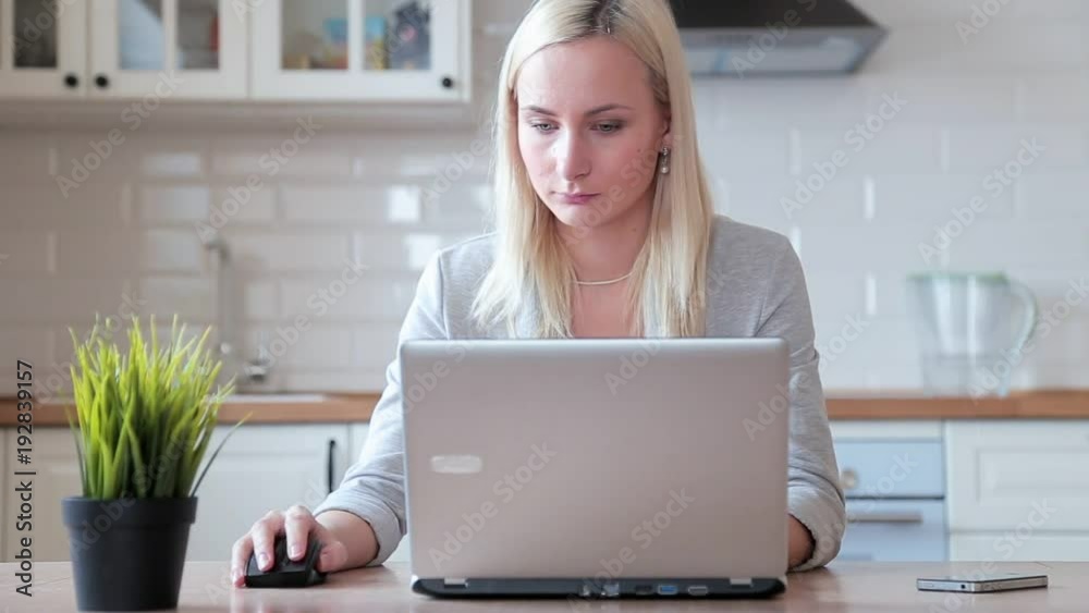 a woman working at a computer at home a woman working at a computer at home