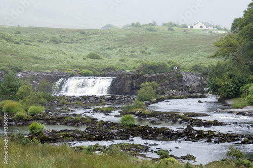 A waterfall on an overcast day with limited visibility.