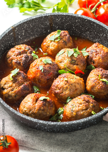 Meatballs in tomato sauce in a frying pan. 