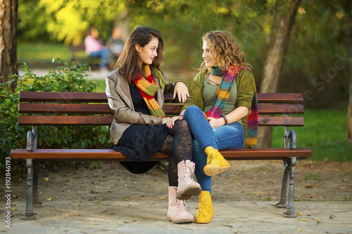Girlfriends sitting on a bench