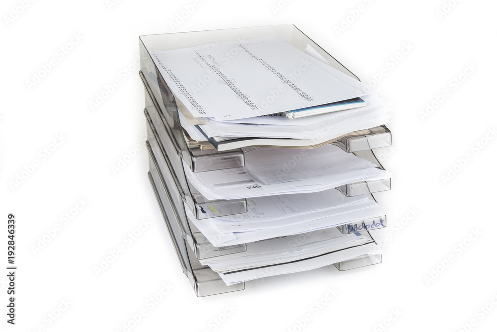 Desktop filing drawers full of papers on the white. Paper office tray. Desktop filing drawers full of papers on the white. Paper office tray.