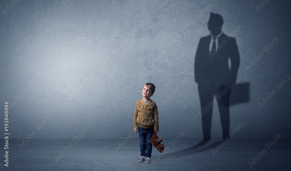Obraz premium Little boy with businessman shadow