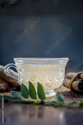 Lemon Ginger tea with all the ingredients on a wooden surface with dark GOTHIC colors.lemon ginger tea is used to improve their health, due to its ability to boost the immune system, etc. photo