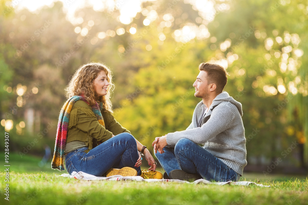 Fototapeta premium Young couple in park flirting