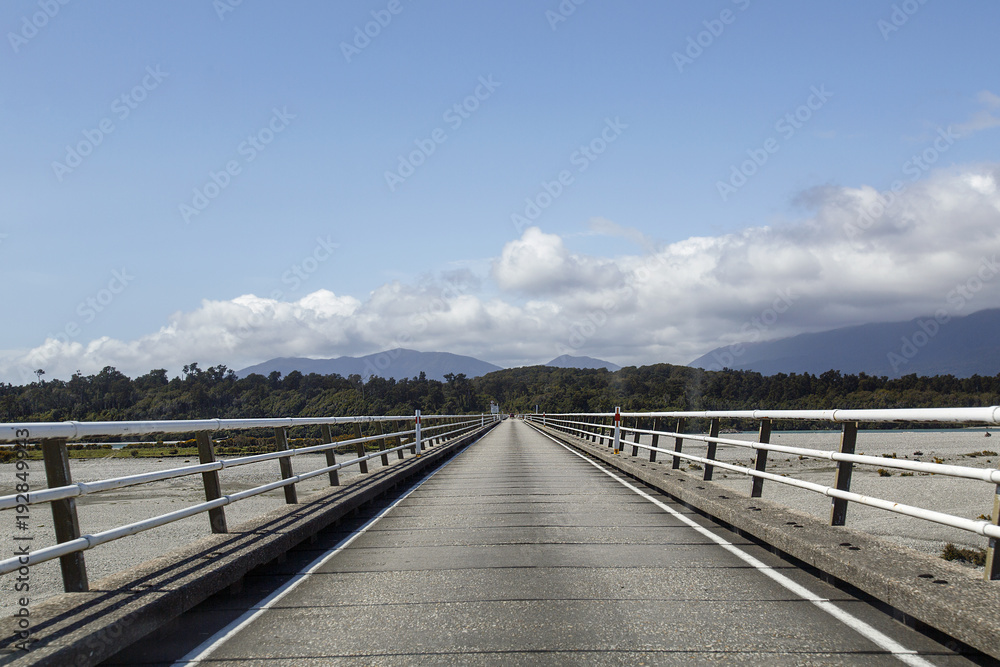 Single track road bridges with a traffic light system are the main way to cross the many rivers in New Zealand. This is the longest one which crosses the Haast River - Westland.