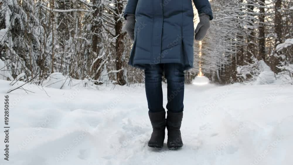 Close-up of the frozen legs of a woman in boots in the snow jumping from the cold. Close-up of the frozen legs of a woman in boots in the snow jumping from the cold.