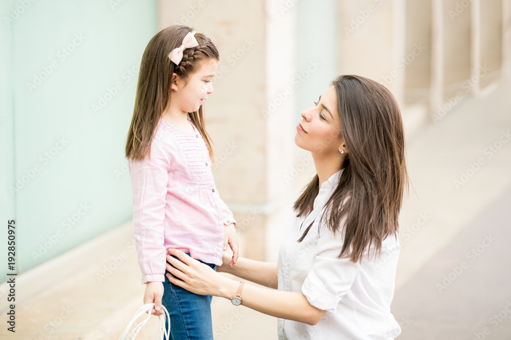 Pretty latin mother and daughter after shopping spree Pretty latin mother and daughter after shopping spree